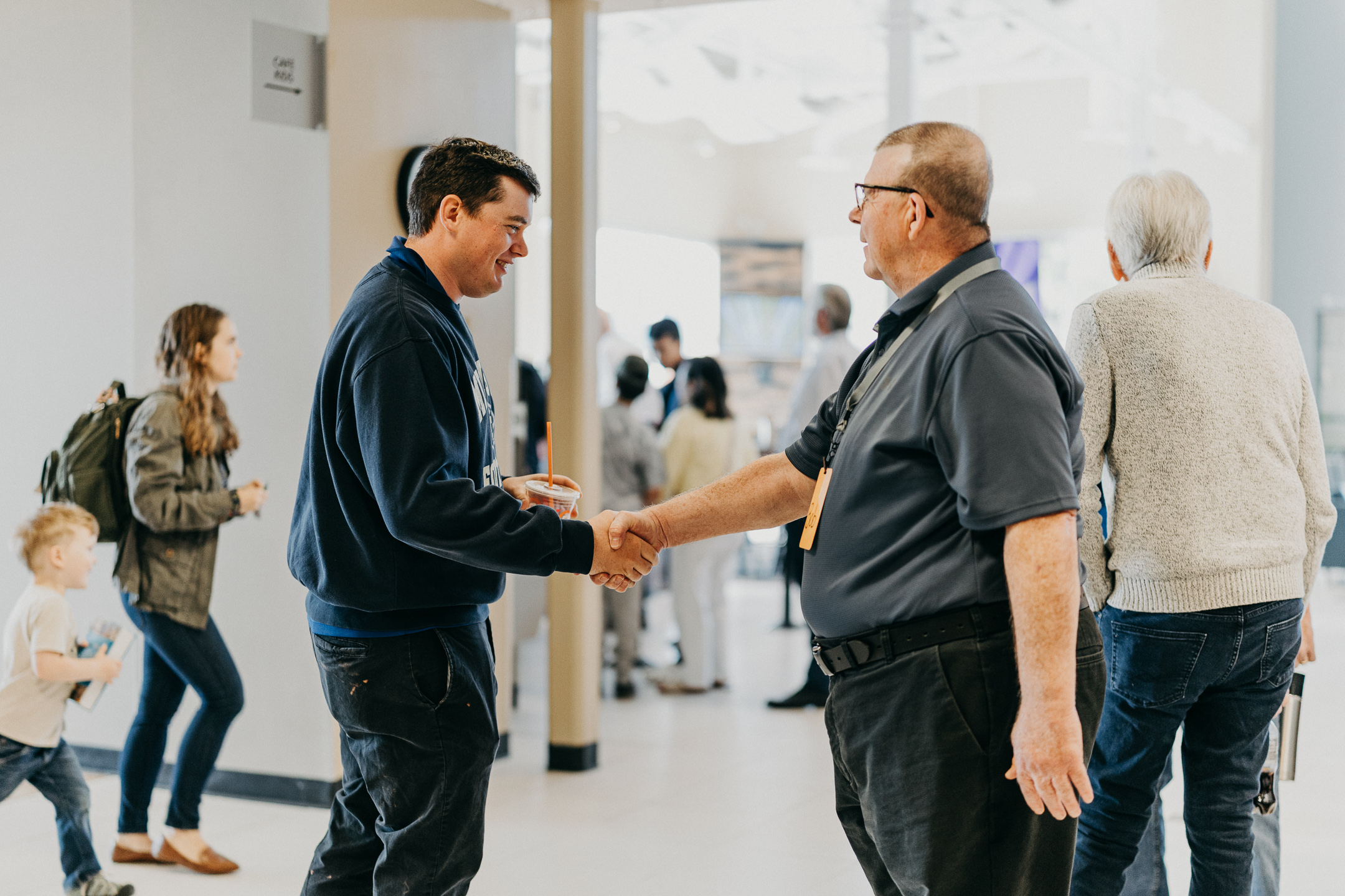 volunteer at church shaking hands